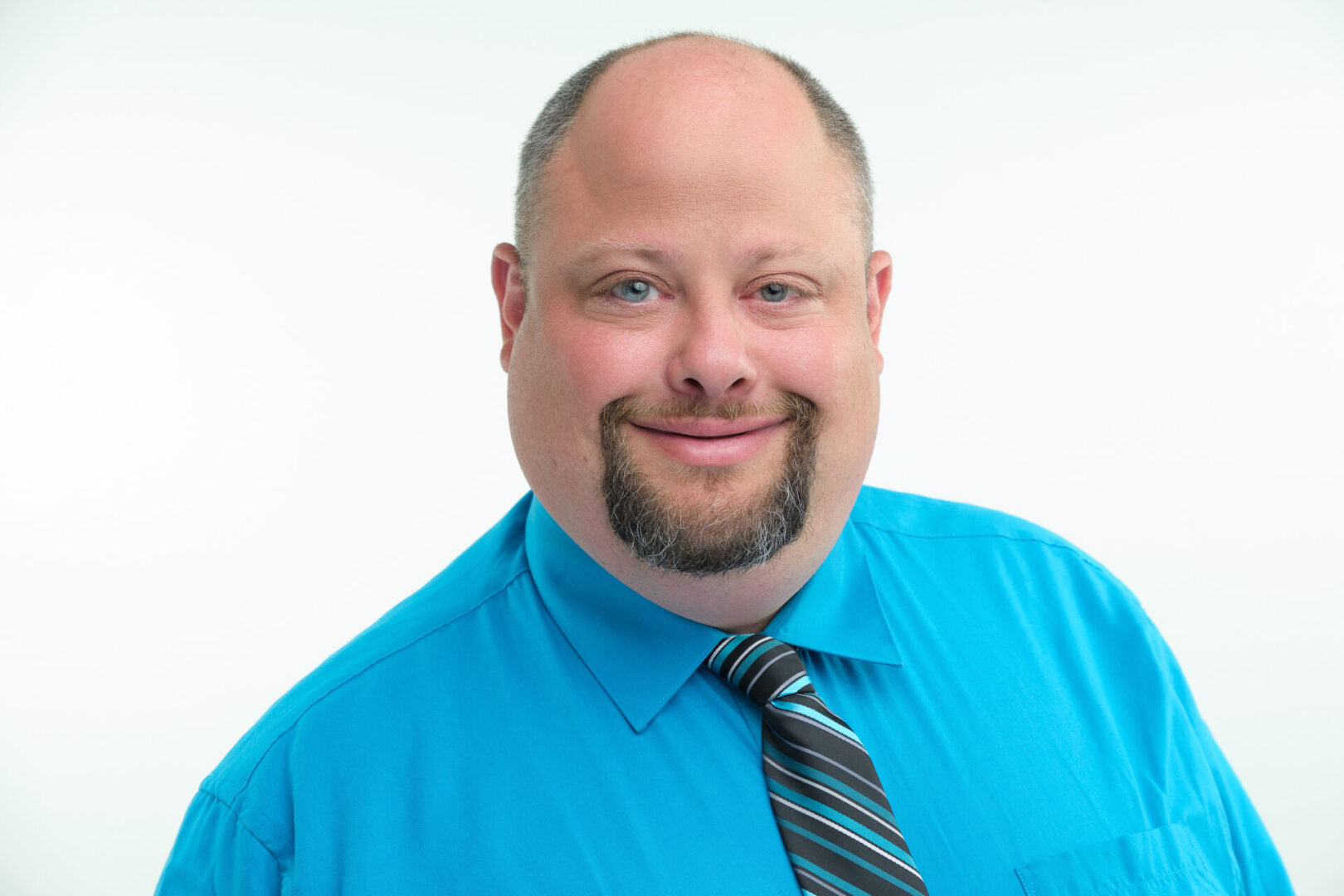 A man with a beard and blue shirt