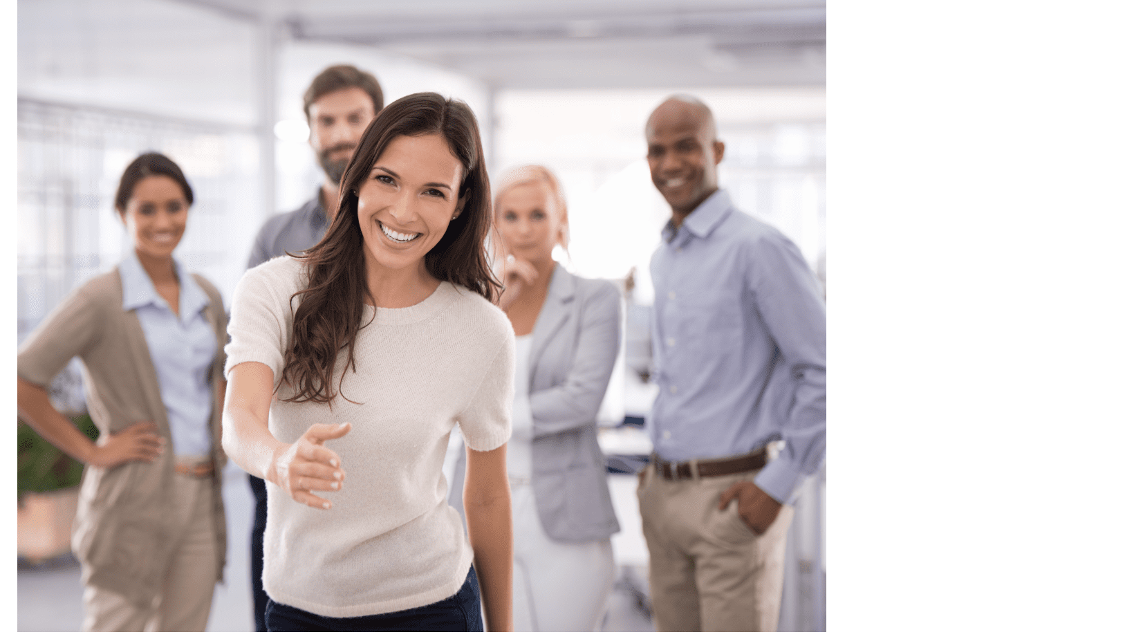 A group of people standing in an office.